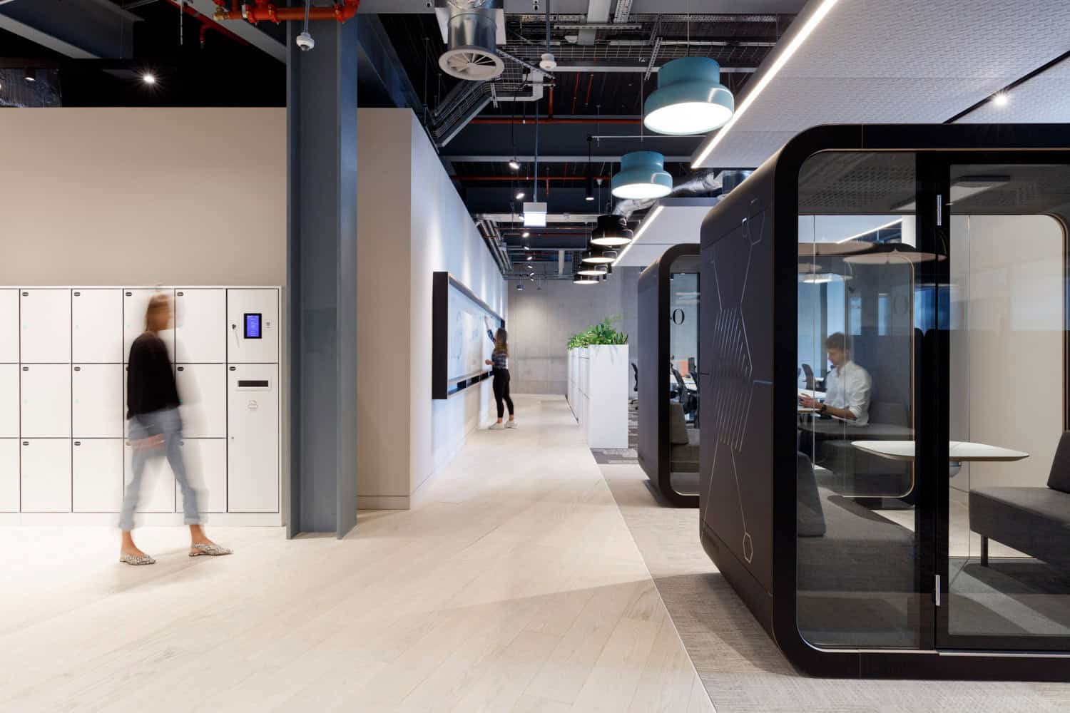 Modern workplace with smart lockers and acoustic pods